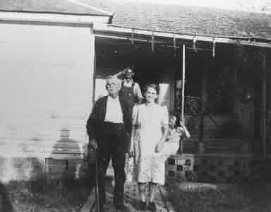 Jack and Jennie Crawford with Herb on the porch.